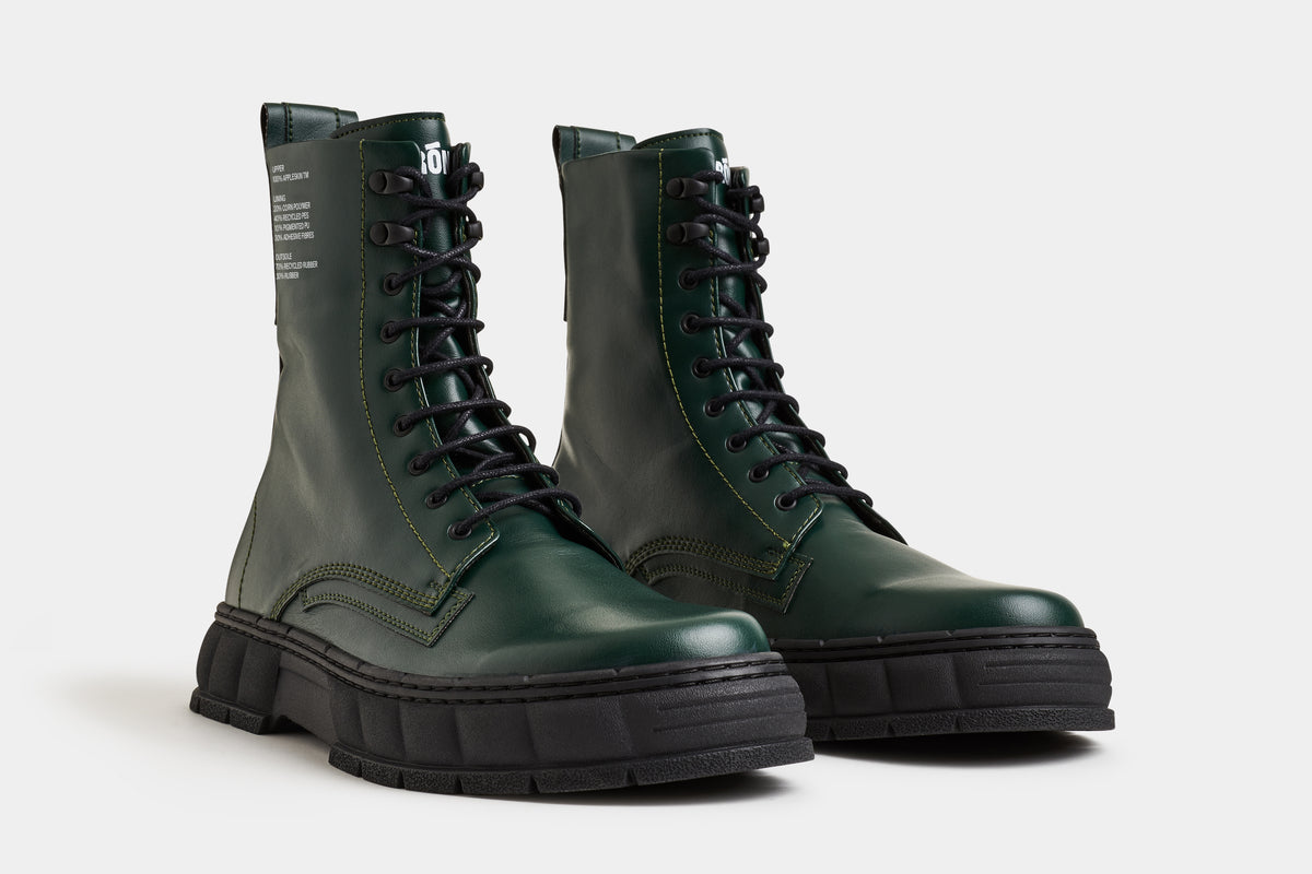 vegan leather 1992 combat boot in dark green from the front 