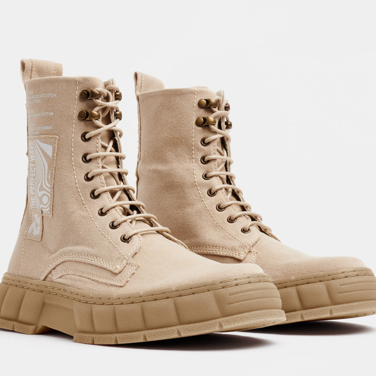 1992 Vegan combat boot out of recycled surplus army tents in sand shown from the front