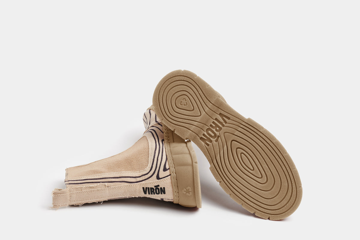 1997 Vegan Chelsea boot made from recycled cotton in beige with line elements shown from the bottom